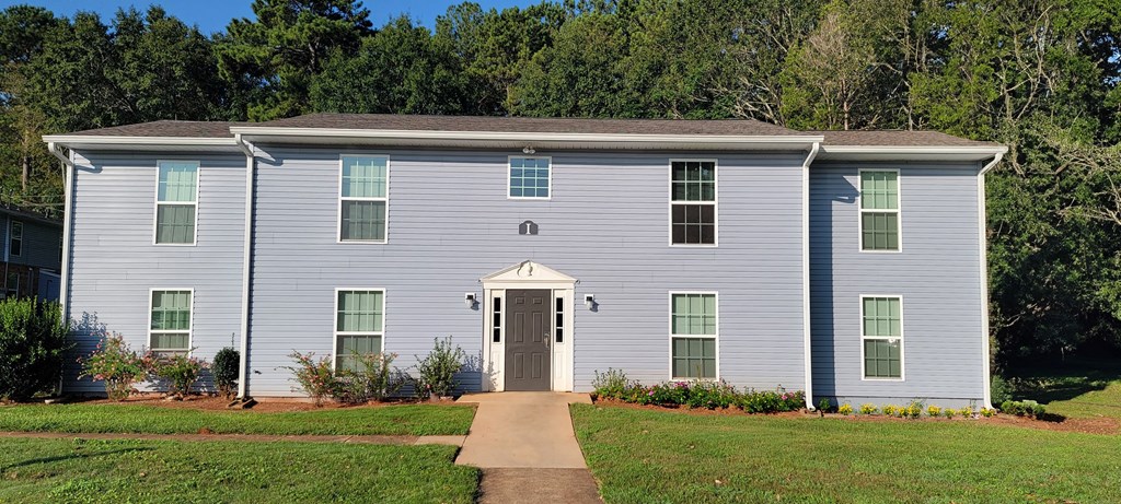 a white house with a sidewalk in front of it