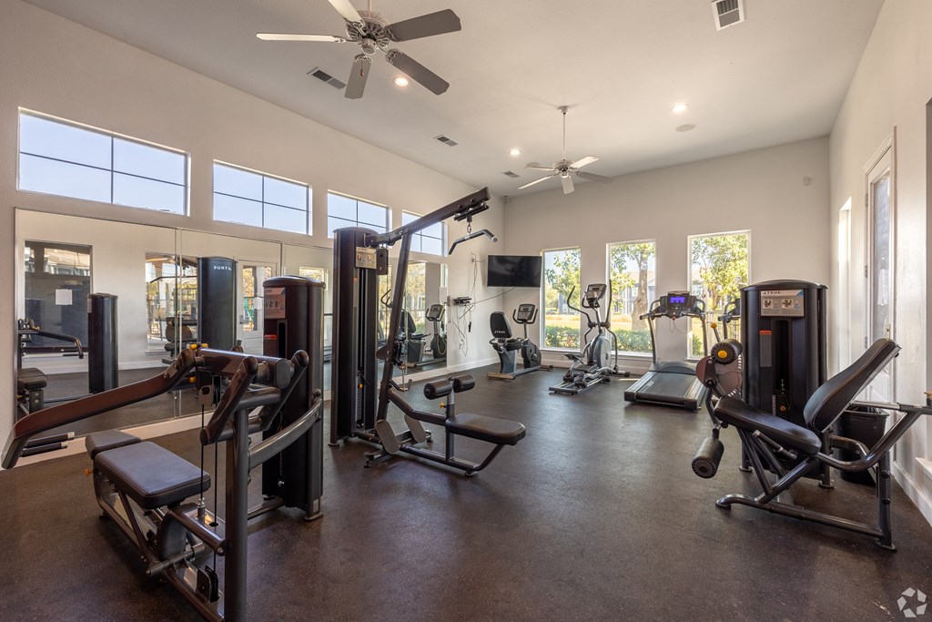 A spacious home gym with a variety of equipment.