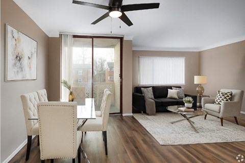 A living room with a dining table and chairs.