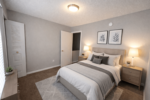 A bedroom with a bed, nightstands, and a window.