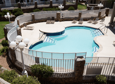 A round swimming pool surrounded by a white fence.