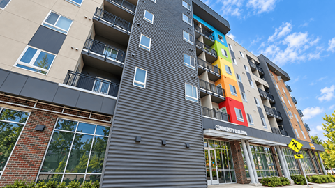 A multi-story building with a Community Living sign on the front.