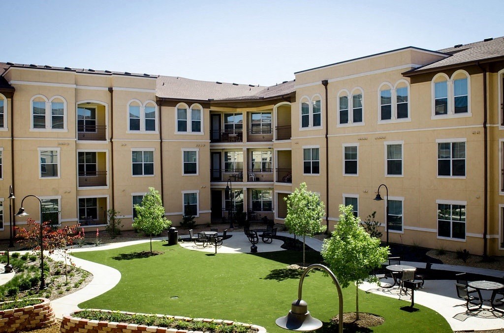 A large building with a courtyard in front of it.
