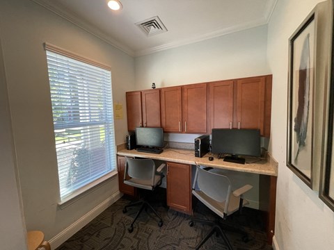an office with two computers on a desk