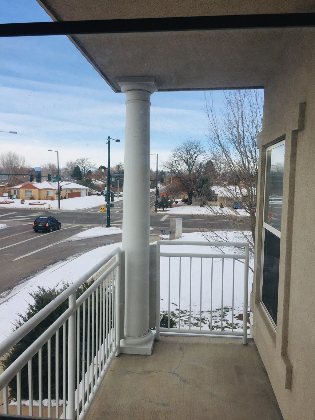 the view from the balcony of a condo building in the snow