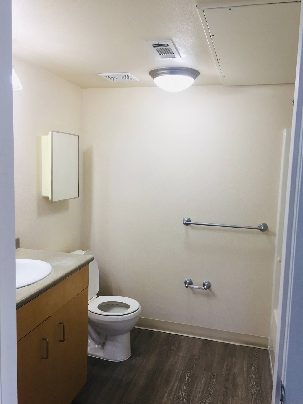 an empty bathroom with a toilet and a sink
