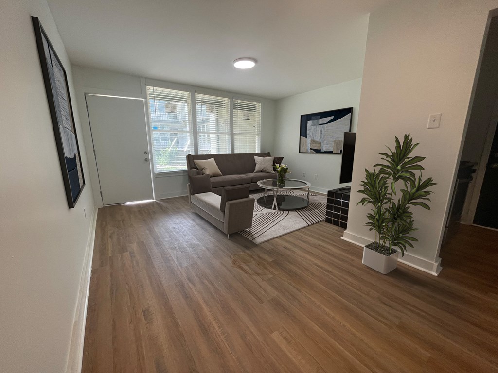 a living room with hardwood floors and a couch at The Courts Midtown, Memphis, Tennessee
