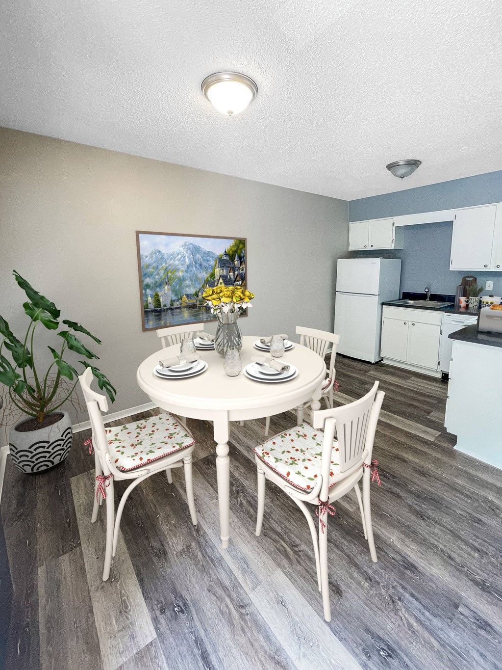 a dining area with a table and chairs and a kitchen in the background at The Junction, Tennessee