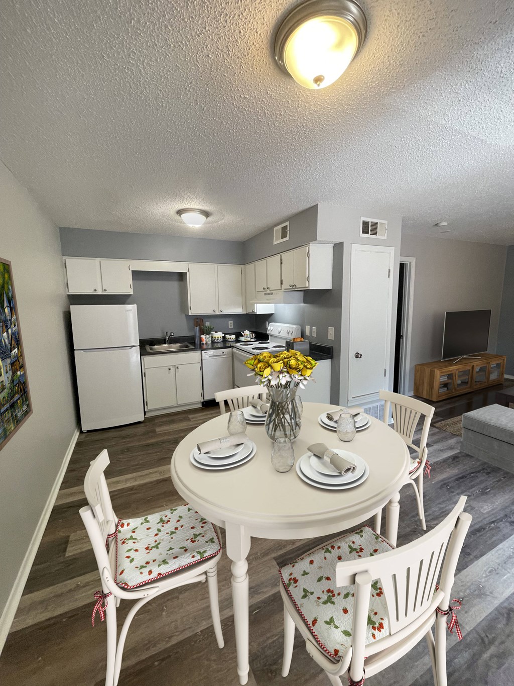 a dining area with a table and chairs and a kitchen in the background at The Junction, Memphis, TN