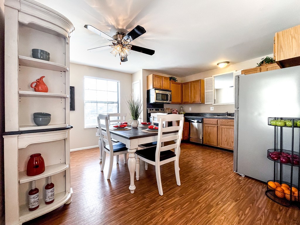 a kitchen and dining room with a table and chairs