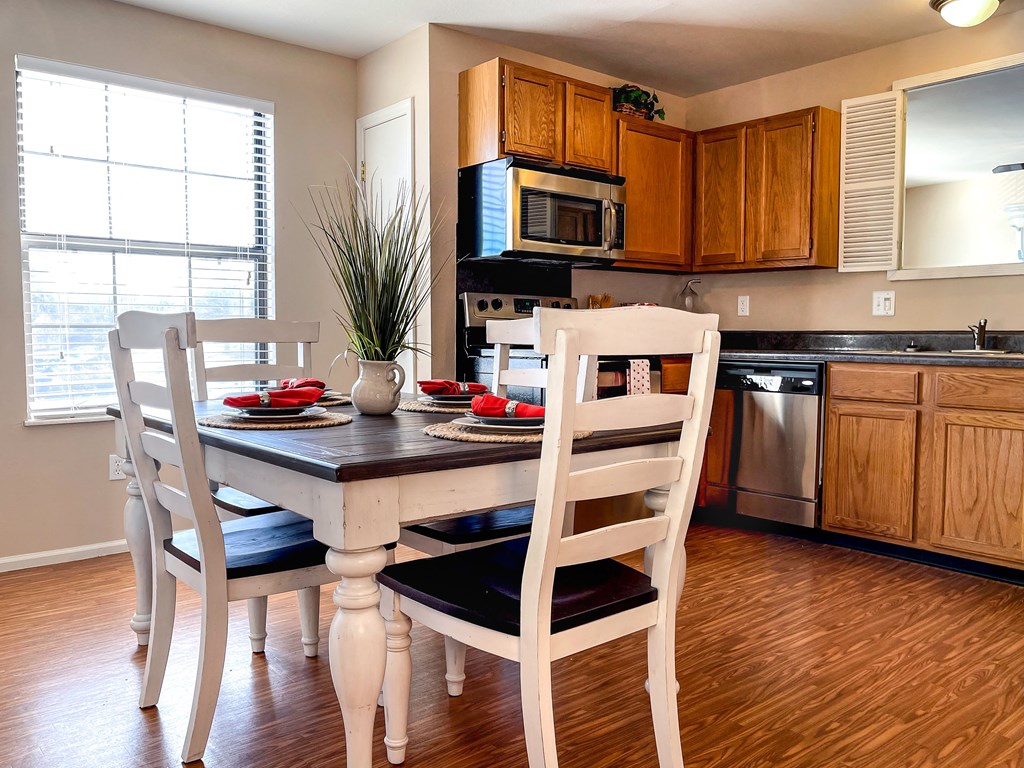a kitchen and dining room with a table and chairs