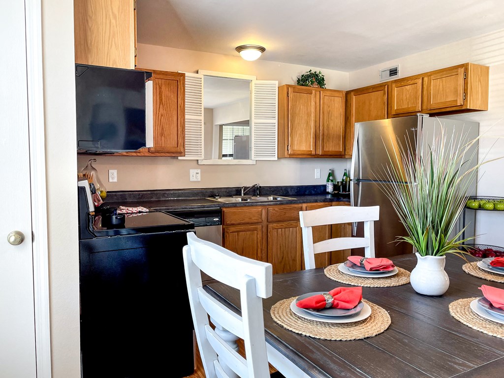a kitchen and dining room with a table and chairs