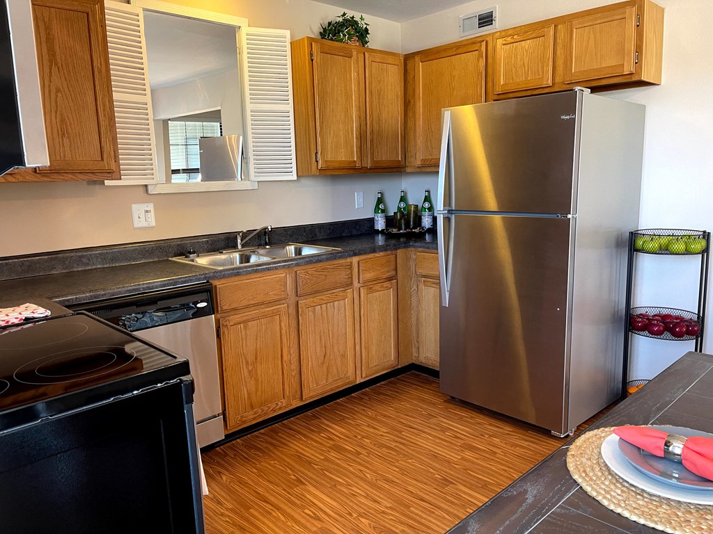 a kitchen with stainless steel appliances and wooden cabinets