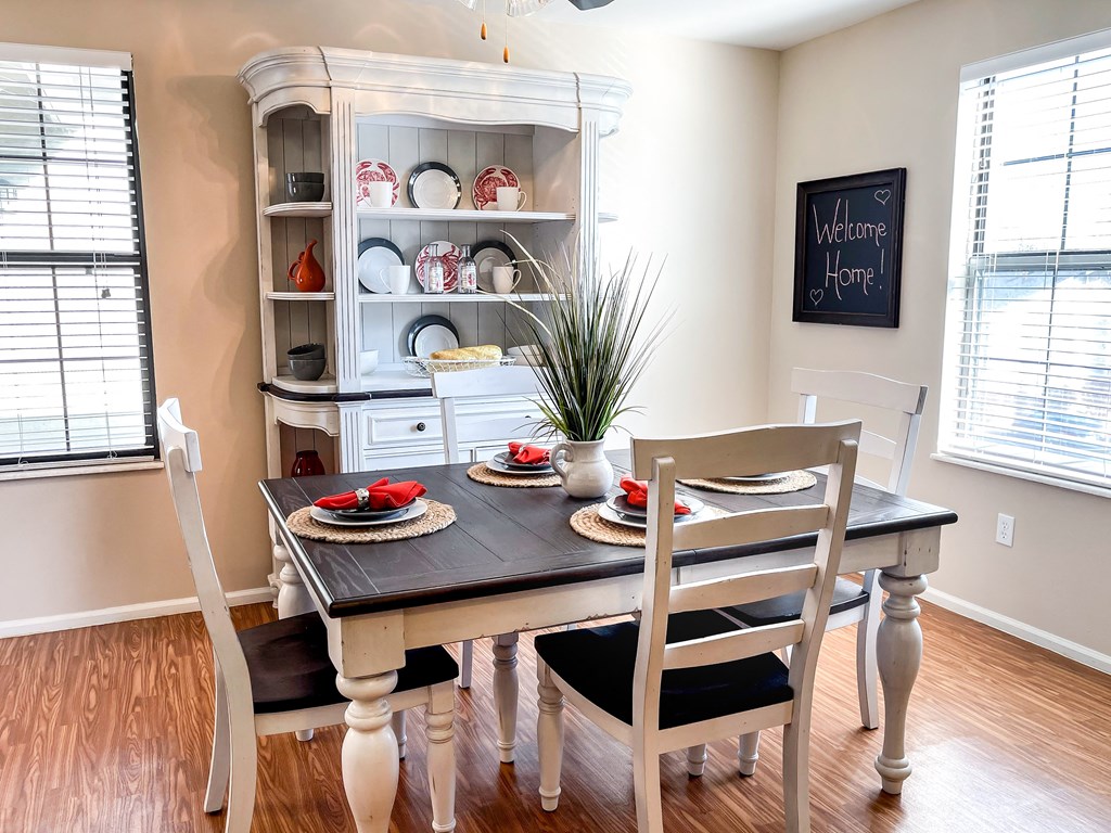 a dining room with a table and chairs and a hutch