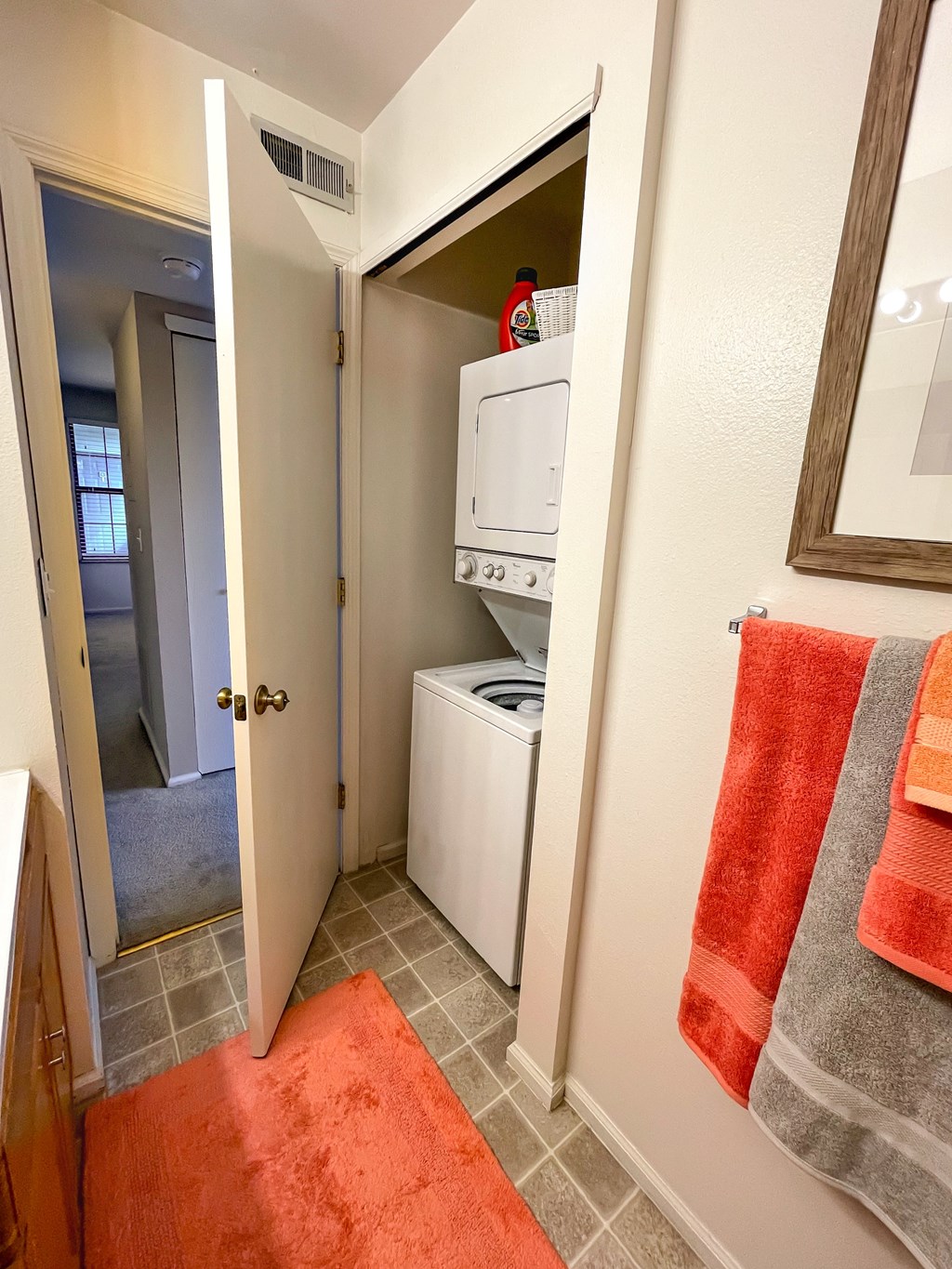the laundry room has a washer and dryer and a door to the bathroom