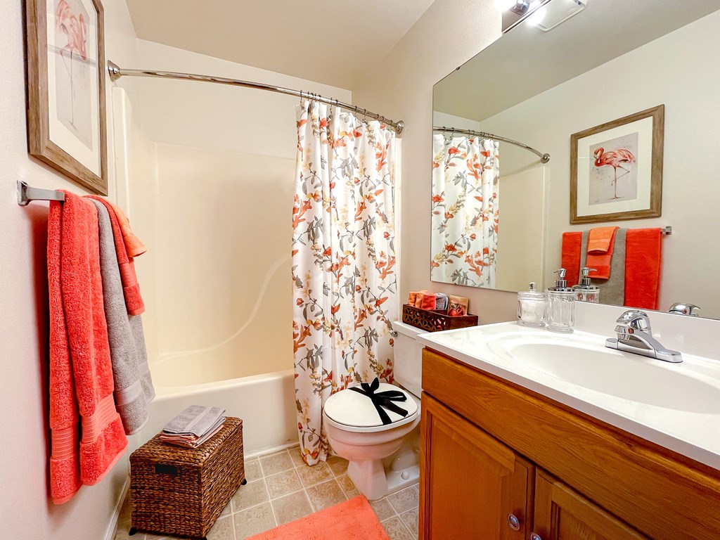 a bathroom with a toilet and a sink and a shower