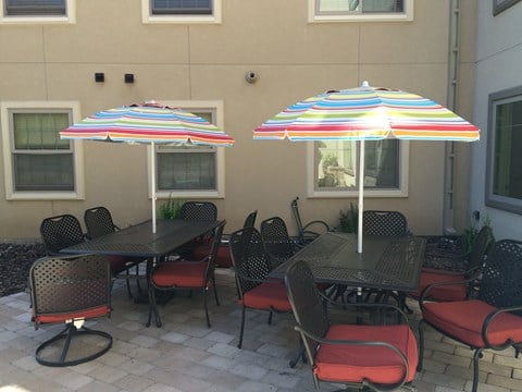 an outside patio with tables and chairs and umbrellas