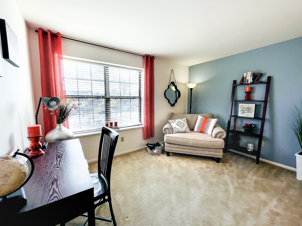 a living room with a couch and a table and a window