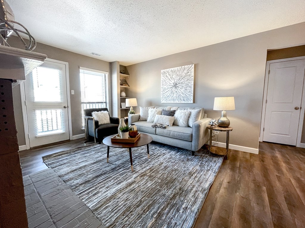 an open living room with a couch and a rug