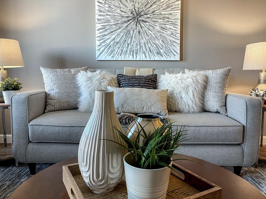 a living room with a gray couch and a table