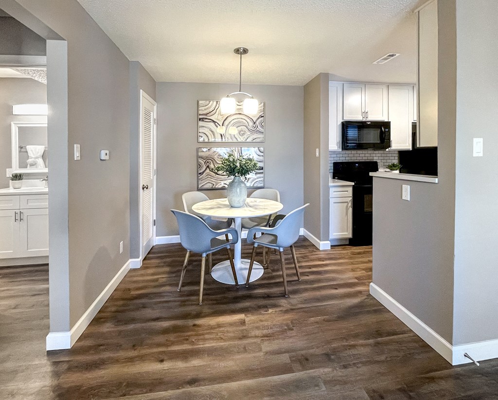 a kitchen and dining room with a table and chairs