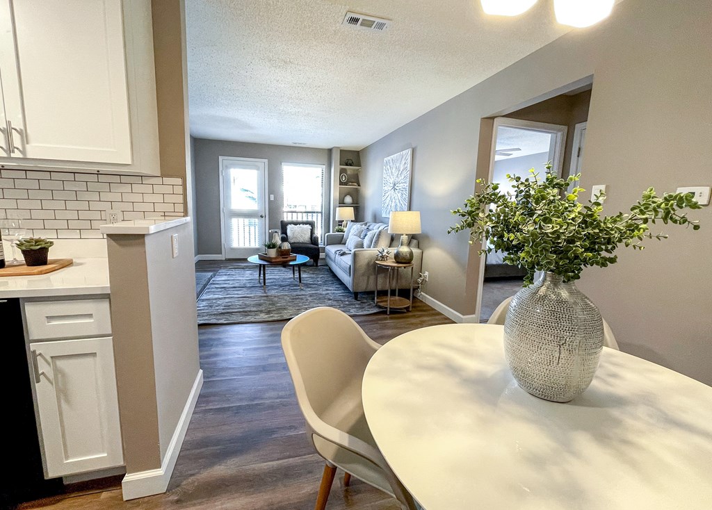 an open living room and dining room with a table and chairs