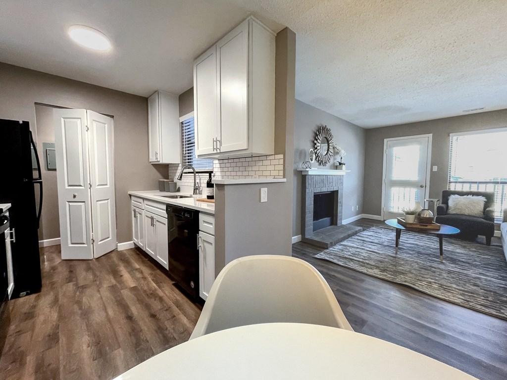 an open kitchen and living room with a table and chairs