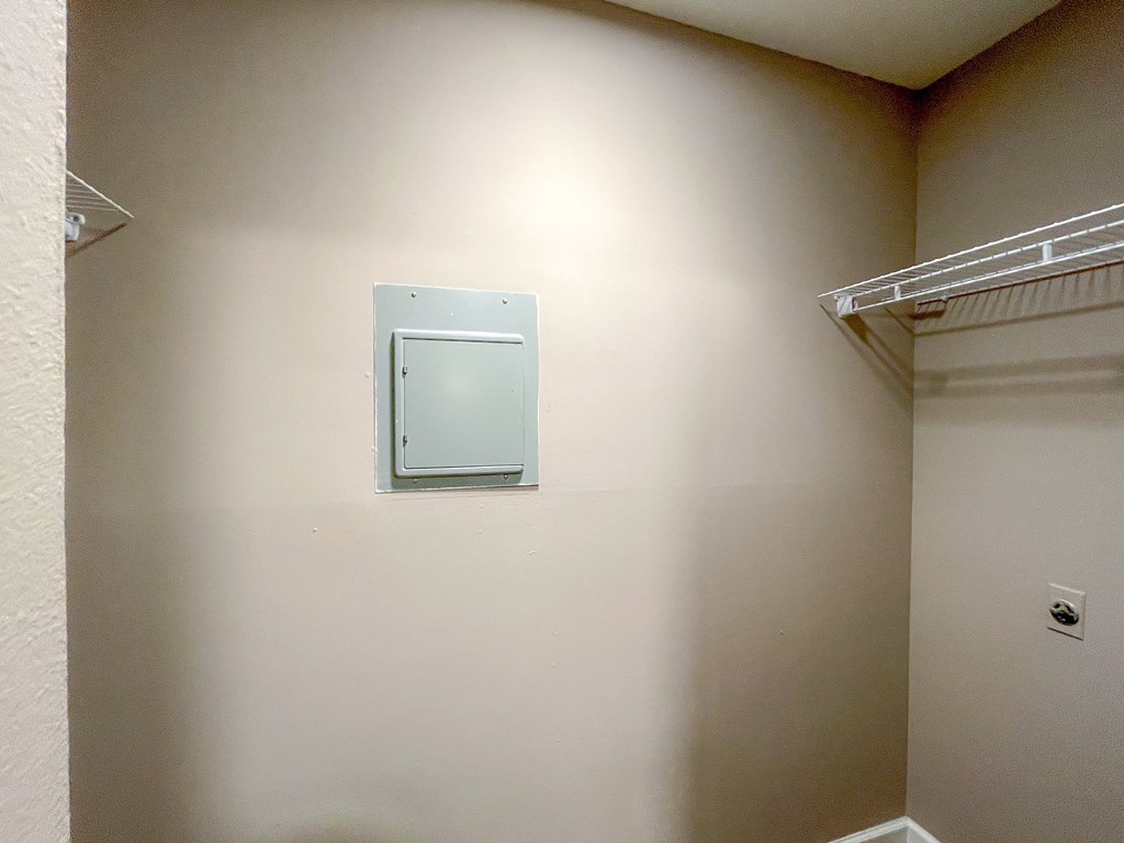 an empty bathroom with a heater on the wall
