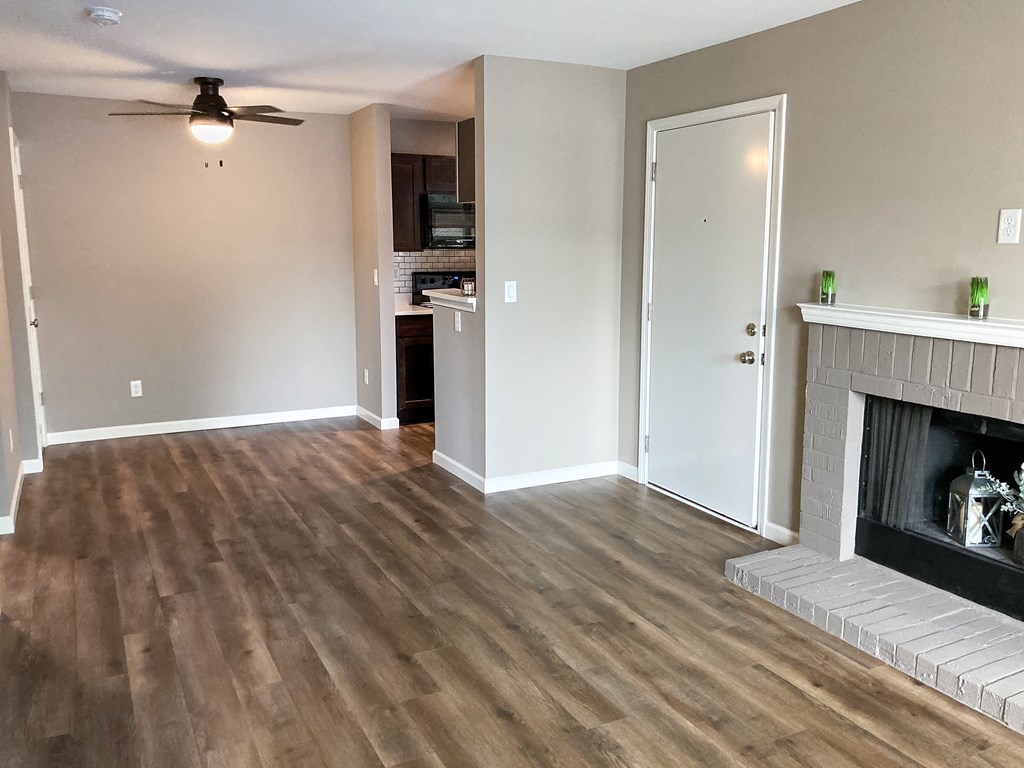 a living room with wood floors and a fireplace