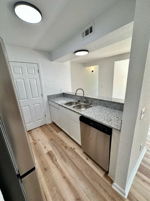 a kitchen with a sink and a dishwasher at Mammoth at the Orchard Apartments, Rogers, AR  