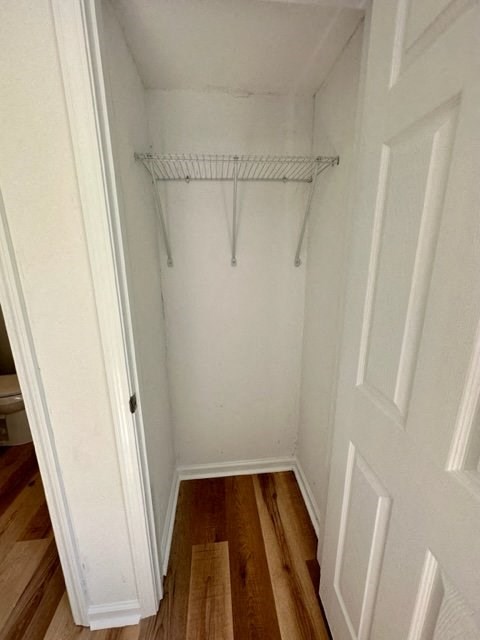 a white closet with a white hanger on the wall