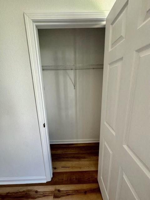 a closet with a white door and a wooden floor