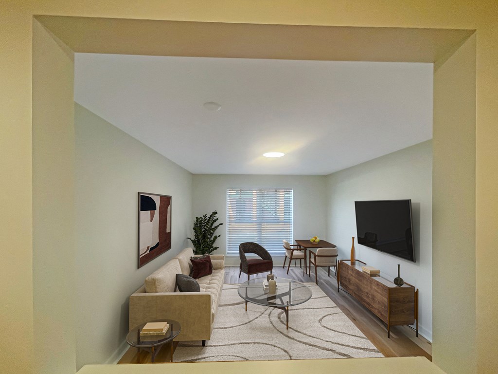 a living room with a couch and a table and a television at The Courts Midtown, Tennessee