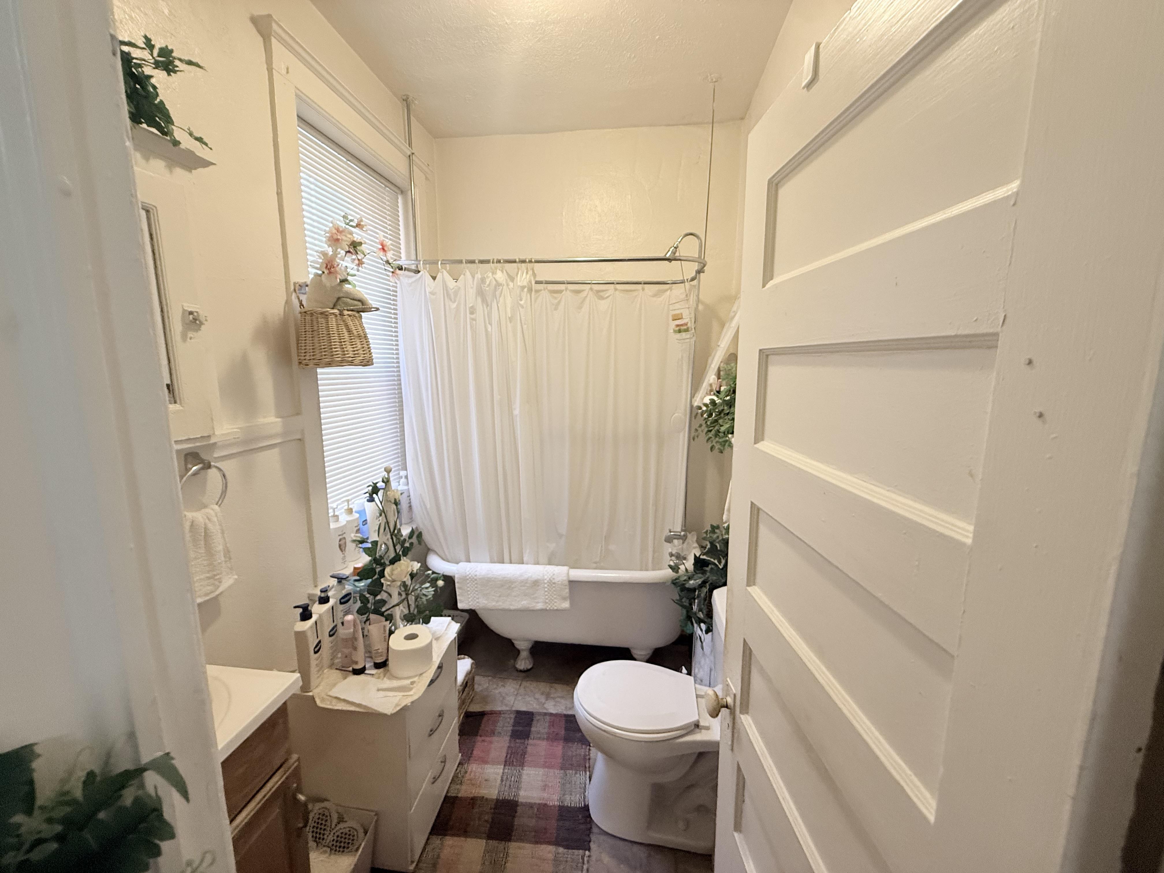 A small bathroom with a toilet, sink, and bathtub.