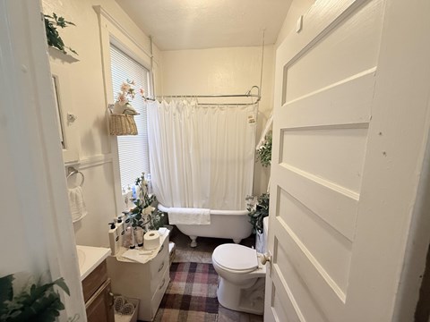 A small bathroom with a toilet, sink, and bathtub.