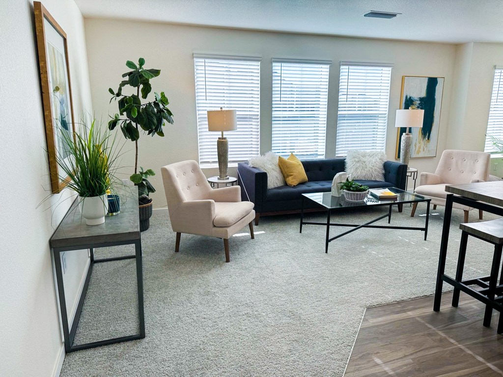 a living room with a couch and chairs and a table