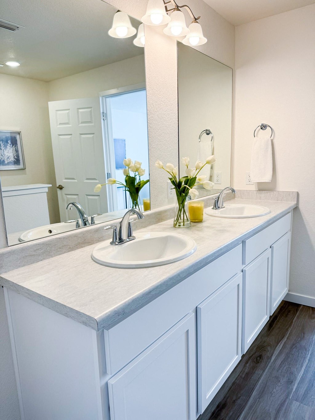 a white bathroom with two sinks and a mirror