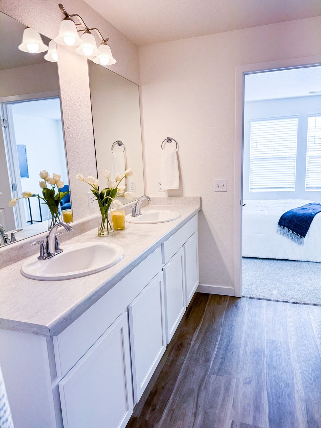 a white bathroom with two sinks and a mirror