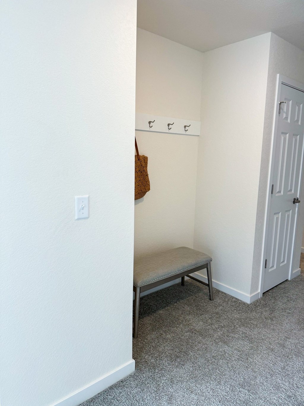 an empty room with a bench and a closet