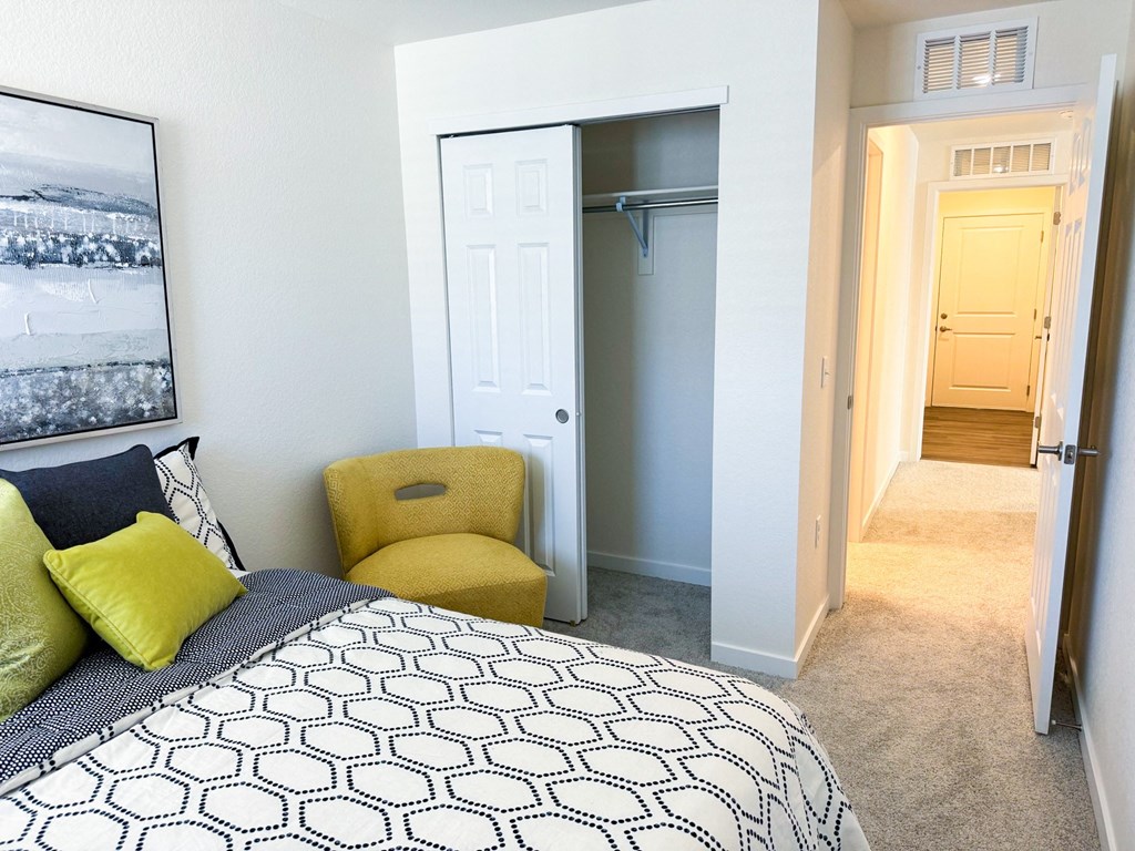 a bedroom with a bed and a doorway to a closet