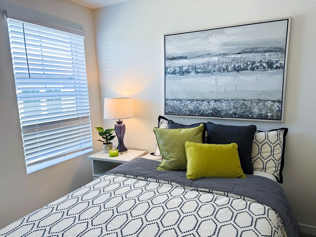 an overview of a bedroom with a bed and a window