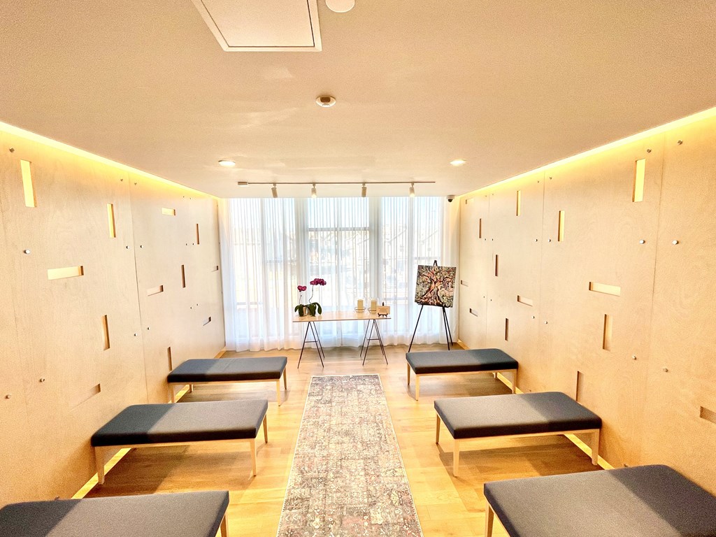 a yoga room with benches and a table in front of a window