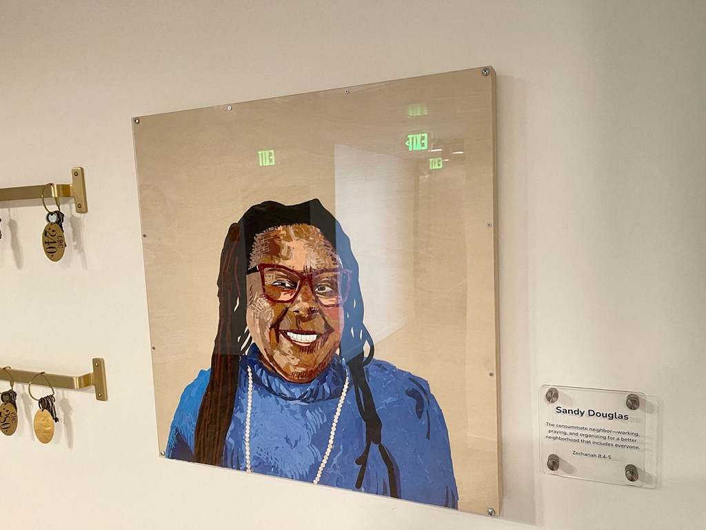 a painting of an old woman on a wall next to a mirror