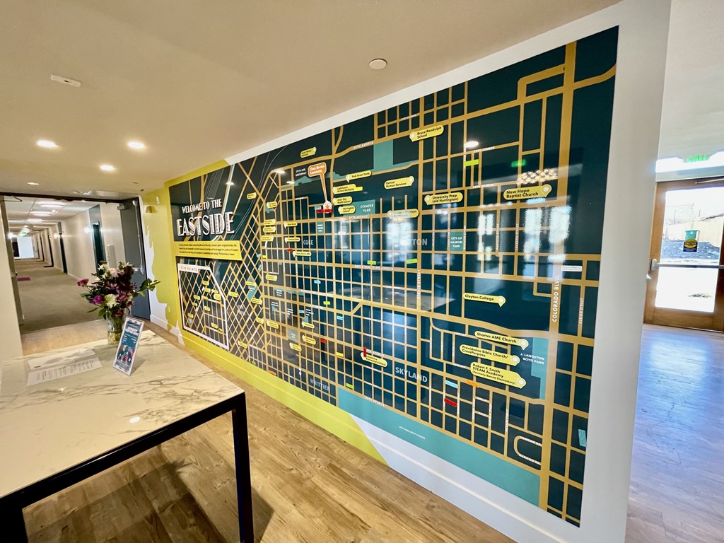 the lobby of a building with a blue wall with a map on it