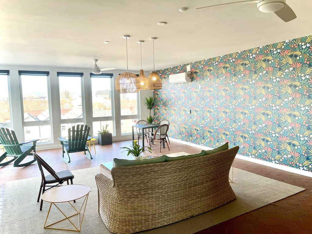 a living room with a couch and chairs and a table