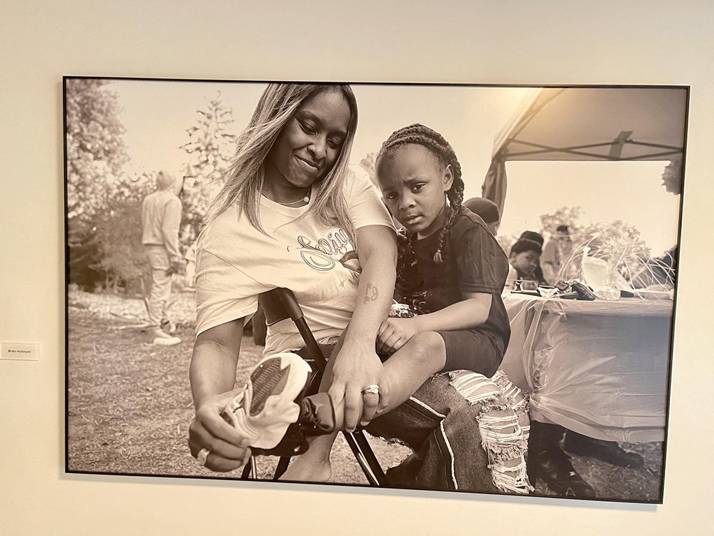 a woman and a girl sitting on a chair in a picture