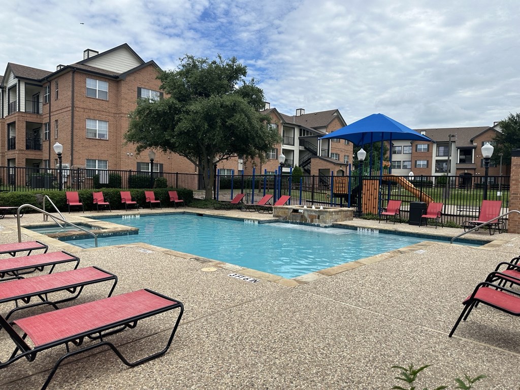 our apartments have a resort style pool with red benches