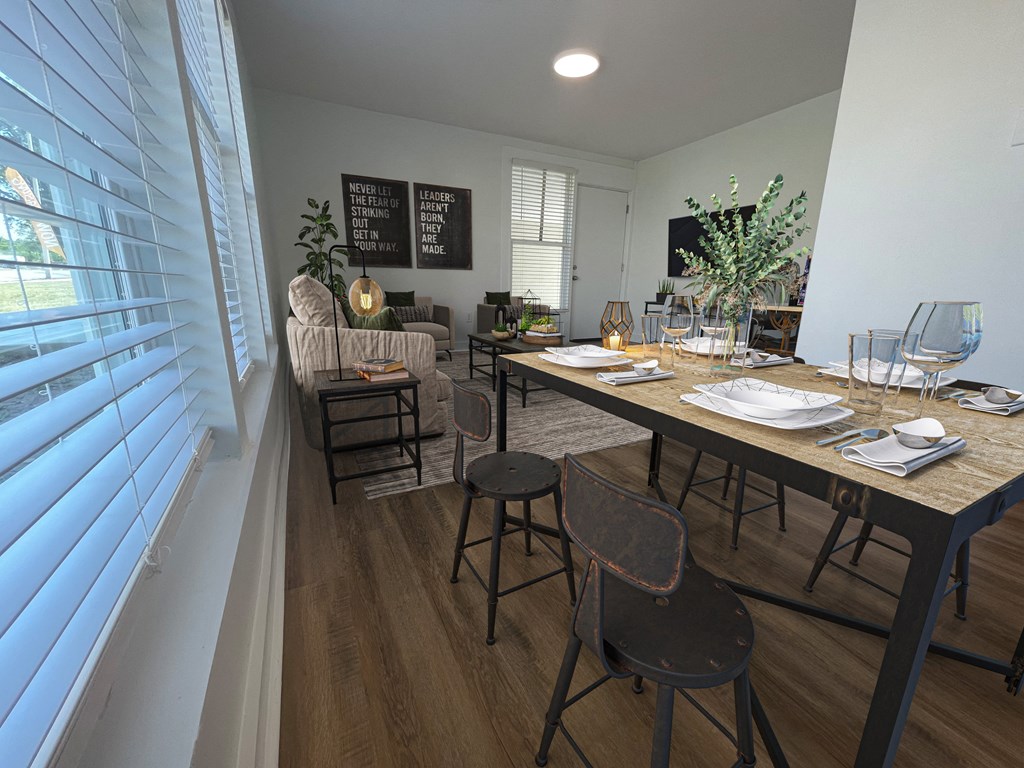 a dining room and living room with a table and chairs  at The Courts Midtown, Memphis