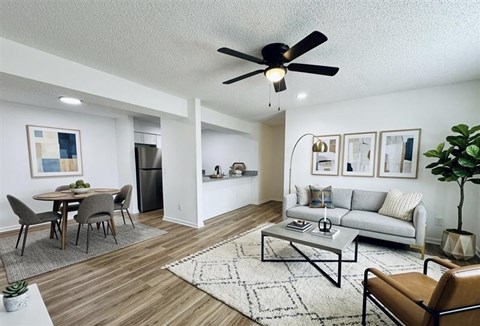 A living room with a dining table and a couch.