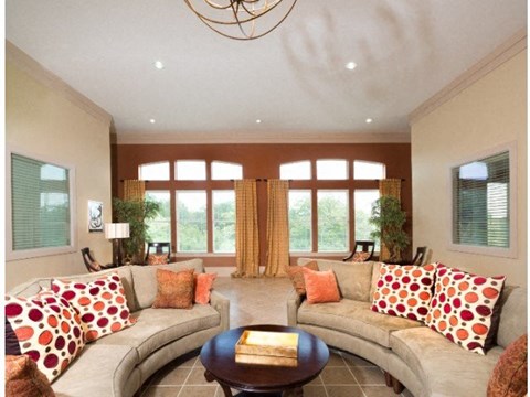 A living room with a grey couch and a brown coffee table.
